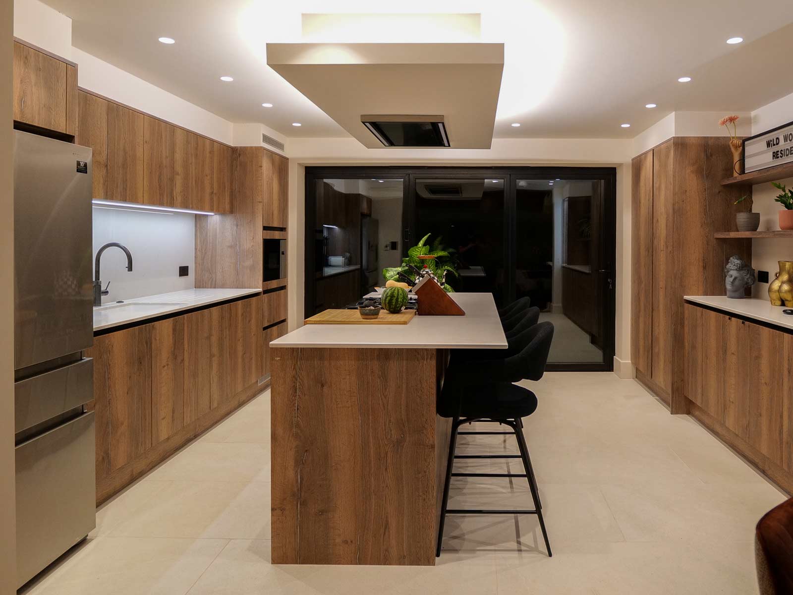 Charlie Brooks’ Scandi kitchen with a kitchen island with bar stools