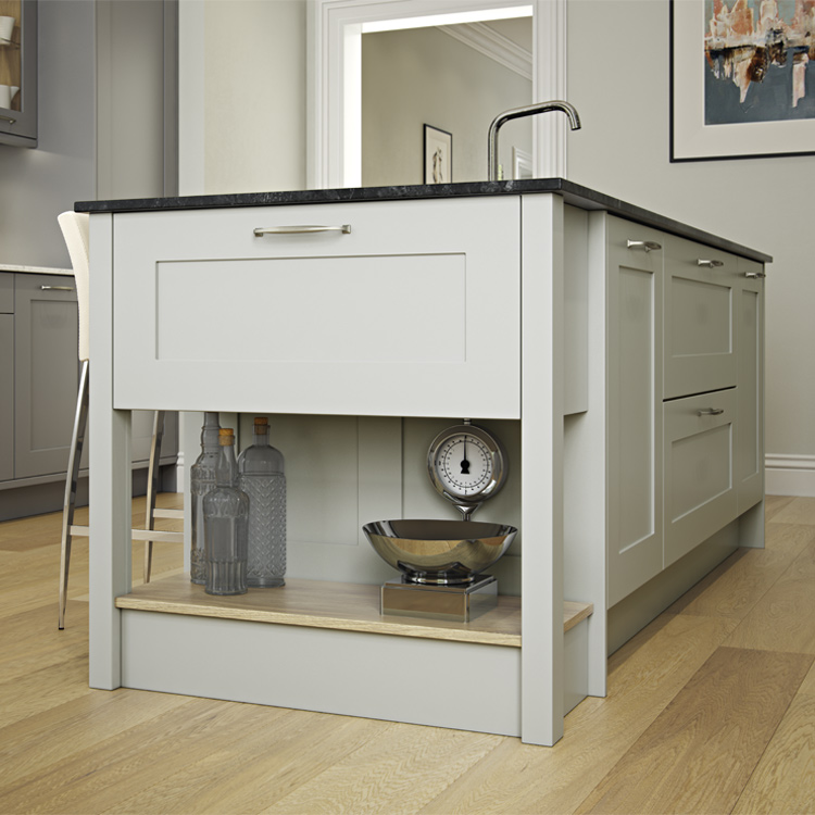 A cook’s table with Shaker kitchen doors and a dark worktop