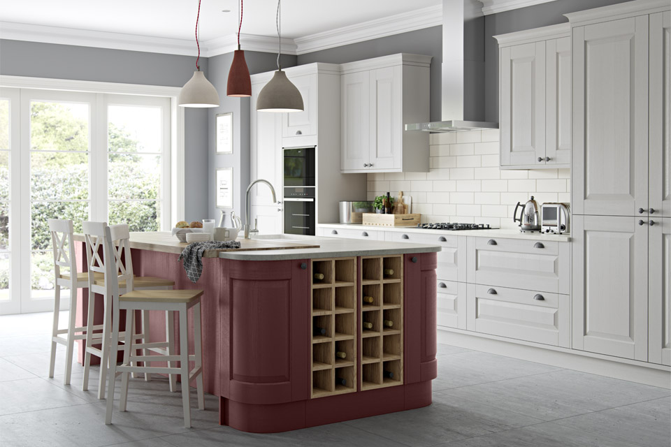 A grey traditional kitchen with a red kitchen island
