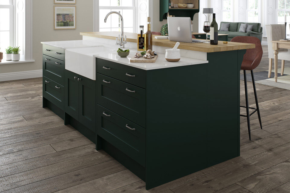 A dark green modern kitchen with dark green shaker kitchen cabinets