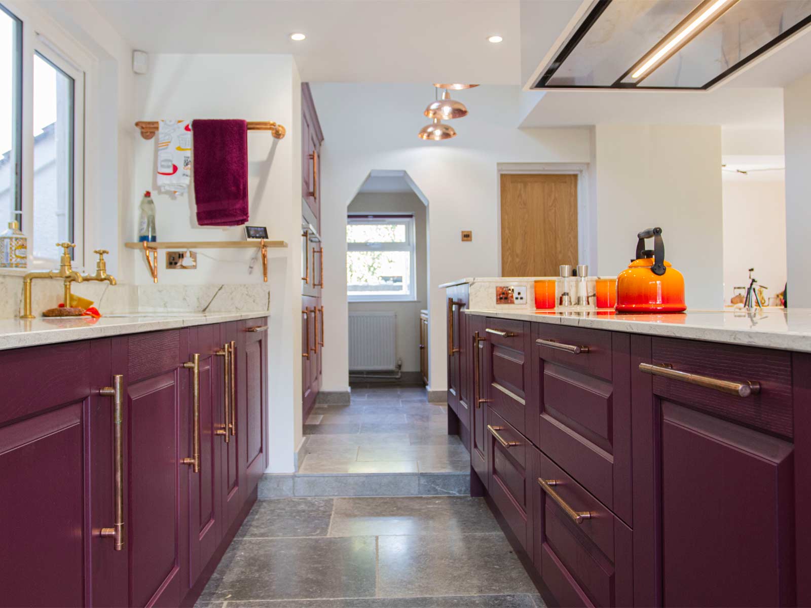 A mid-century design kitchen featuring red cabinets and over-the-top décor