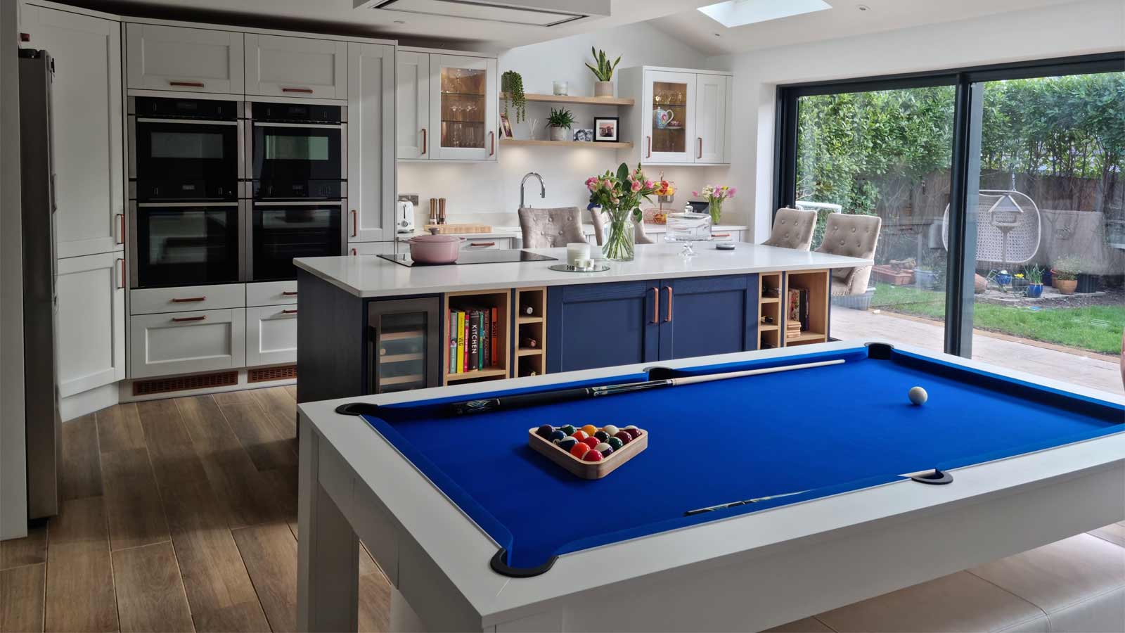 A dopamine kitchen with blue cabinets and retro furniture