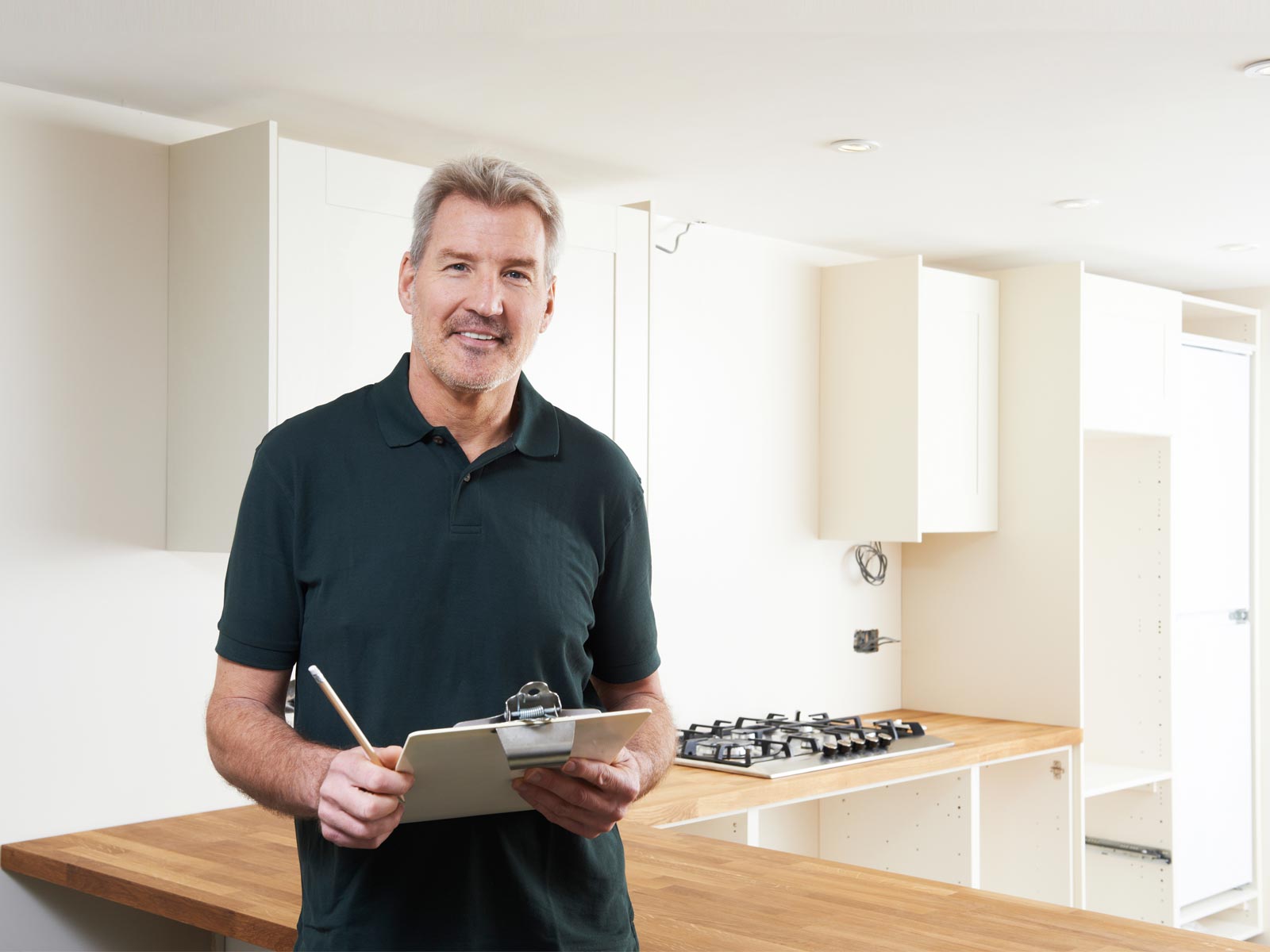 A private kitchen fitter standing in a fitted kitchen