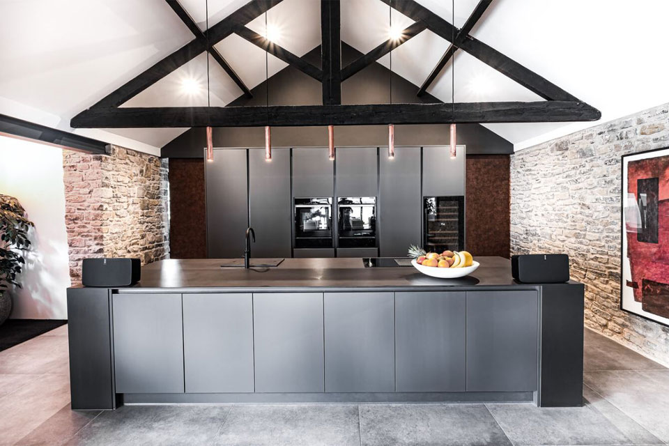 A grey and black industrial kitchen with industrial wall cabinets