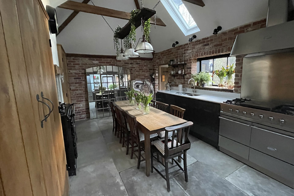 A rustic industrial kitchen with an industrial kitchen oven