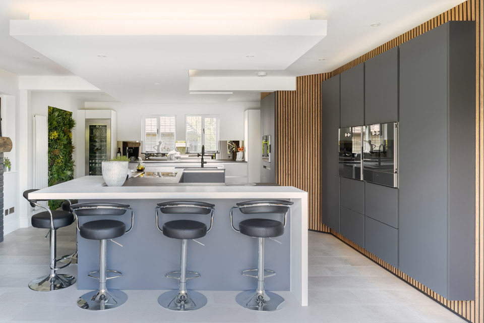 A modern kitchen with industrial kitchen cupboards and a kitchen island