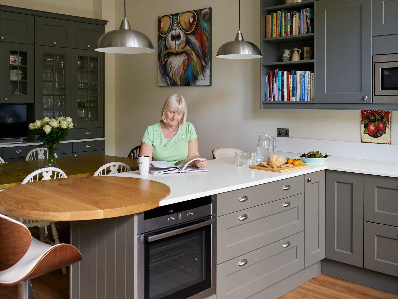 A kitchen peninsula featuring a homeowner in an open plan kitchen  lounge