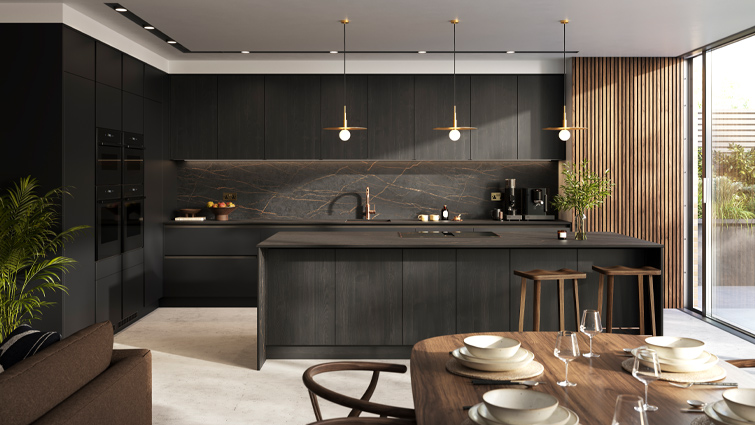 A dark wood kitchen with black and gold kitchen features and dark wood counters