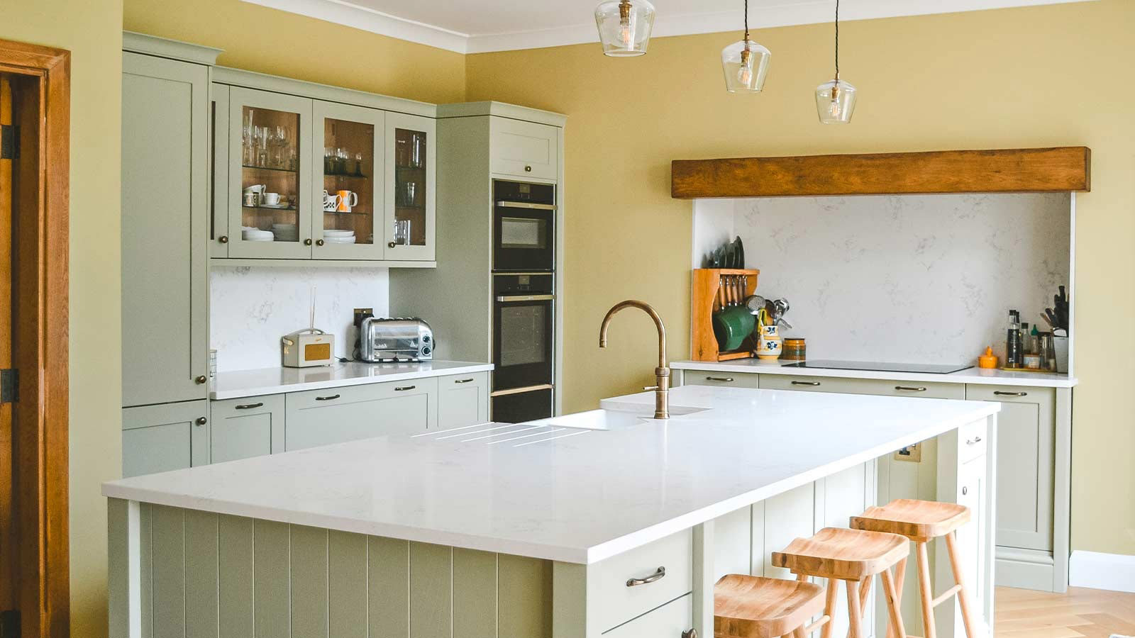 A green Shaker kitchen with earthy green kitchen cabinets