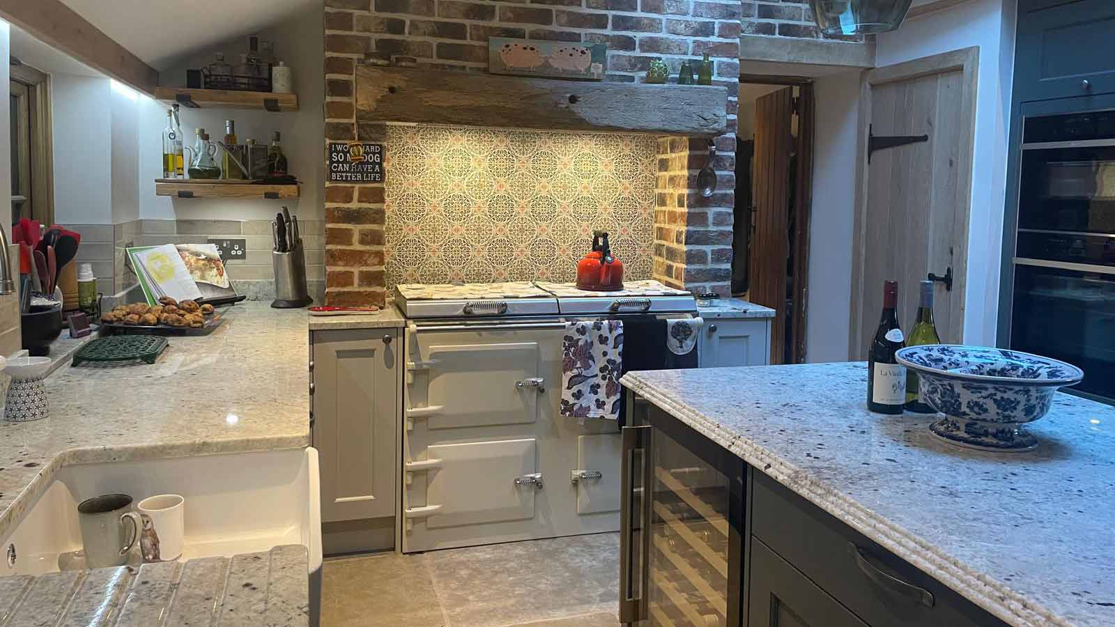 A Victorian kitchen with a grand fireplace Aga