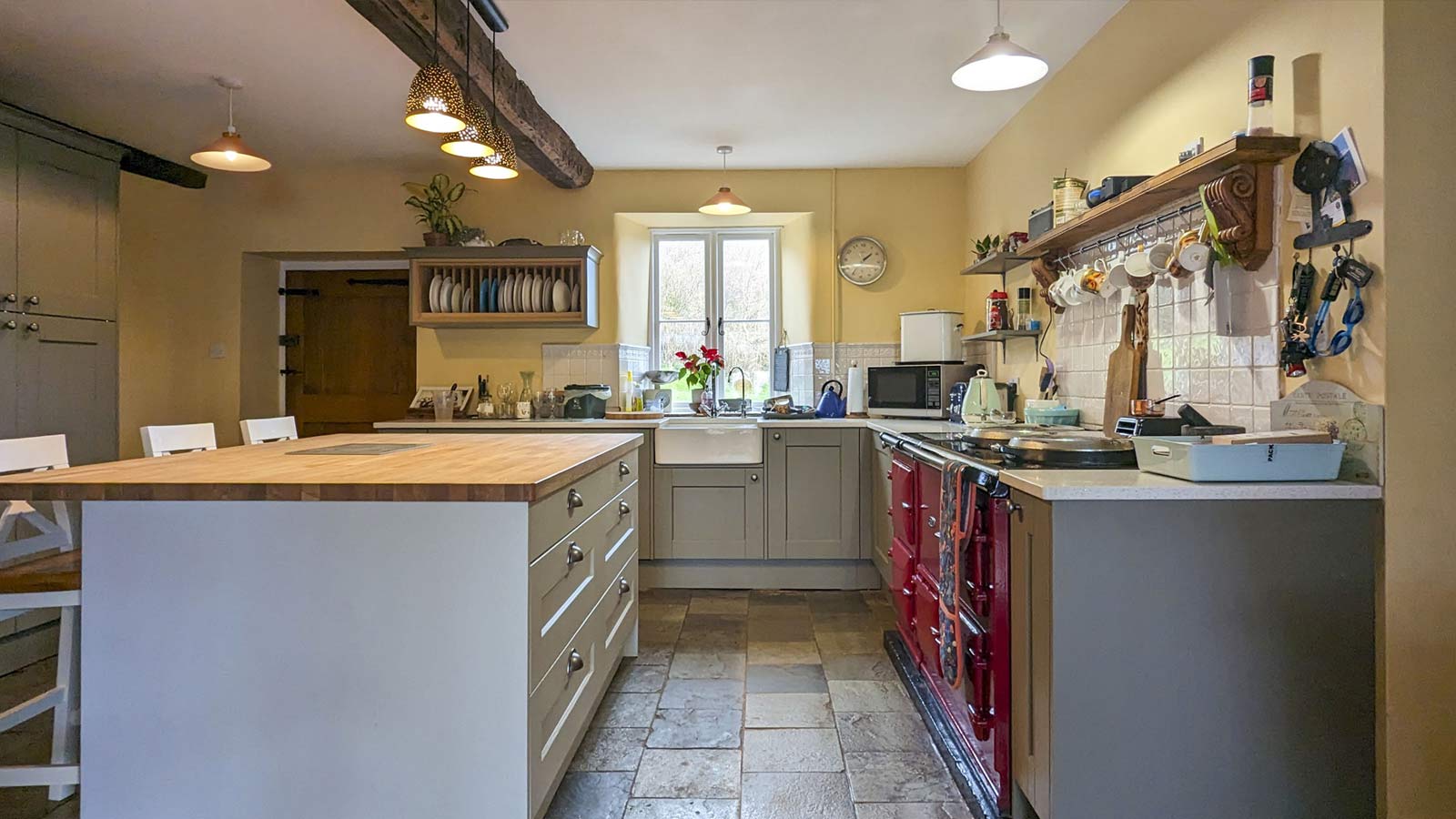 A Victorian kitchen with a grand fireplace Aga