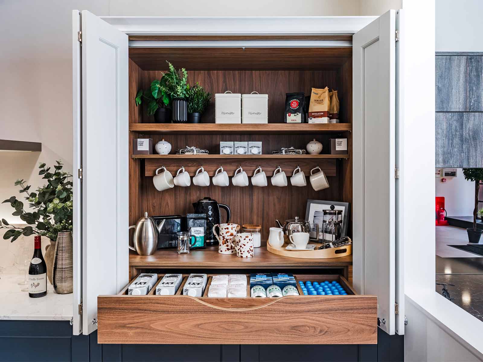 A tea and coffee station within a breakfast cupboard