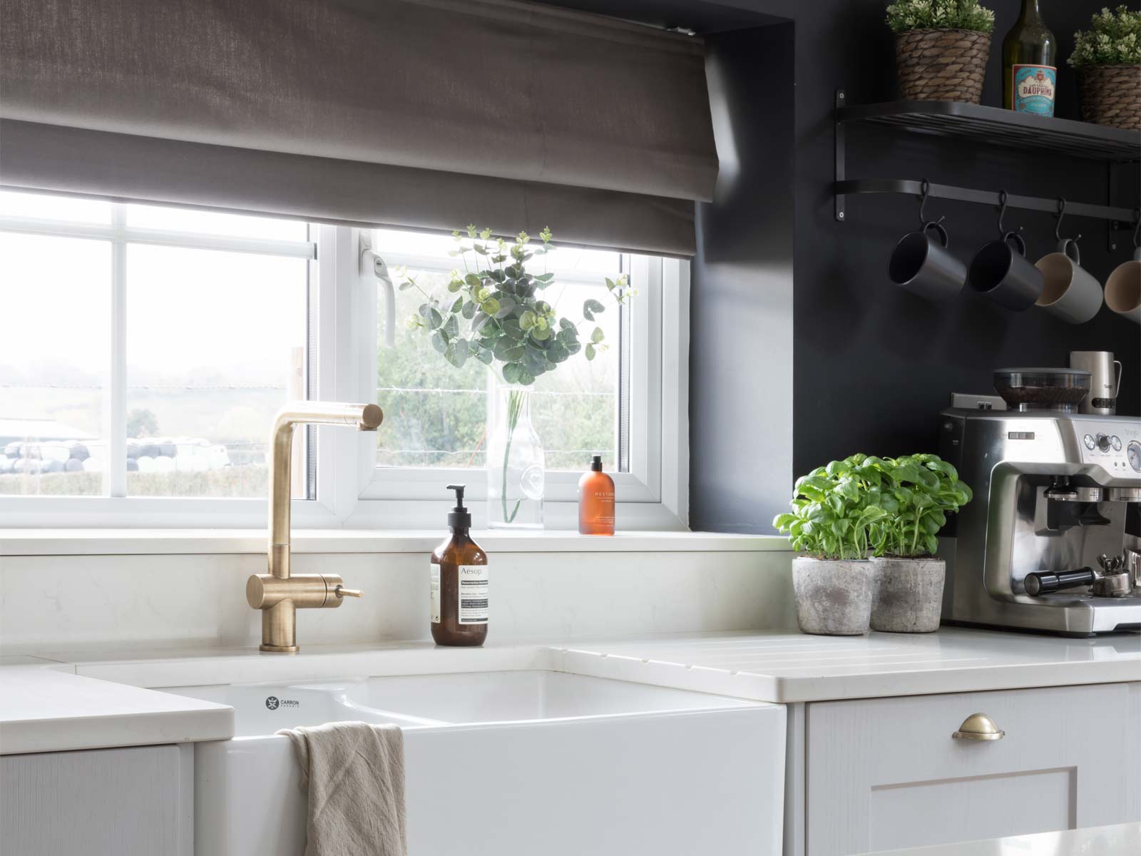 A Nancy Meyers kitchen featuring a butler’s sink