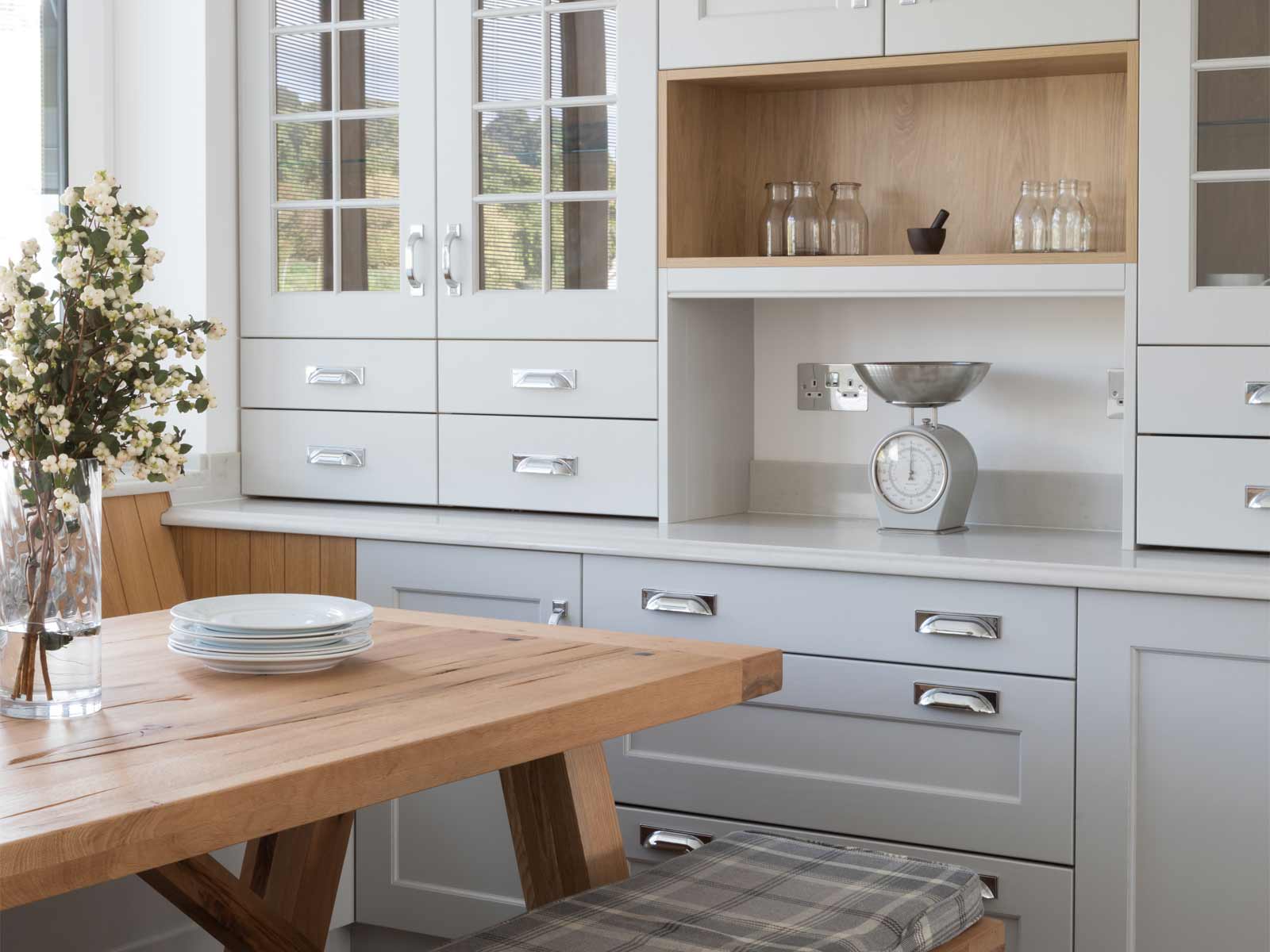 A floral kitchen with wooden wall panels and rustic aesthetics