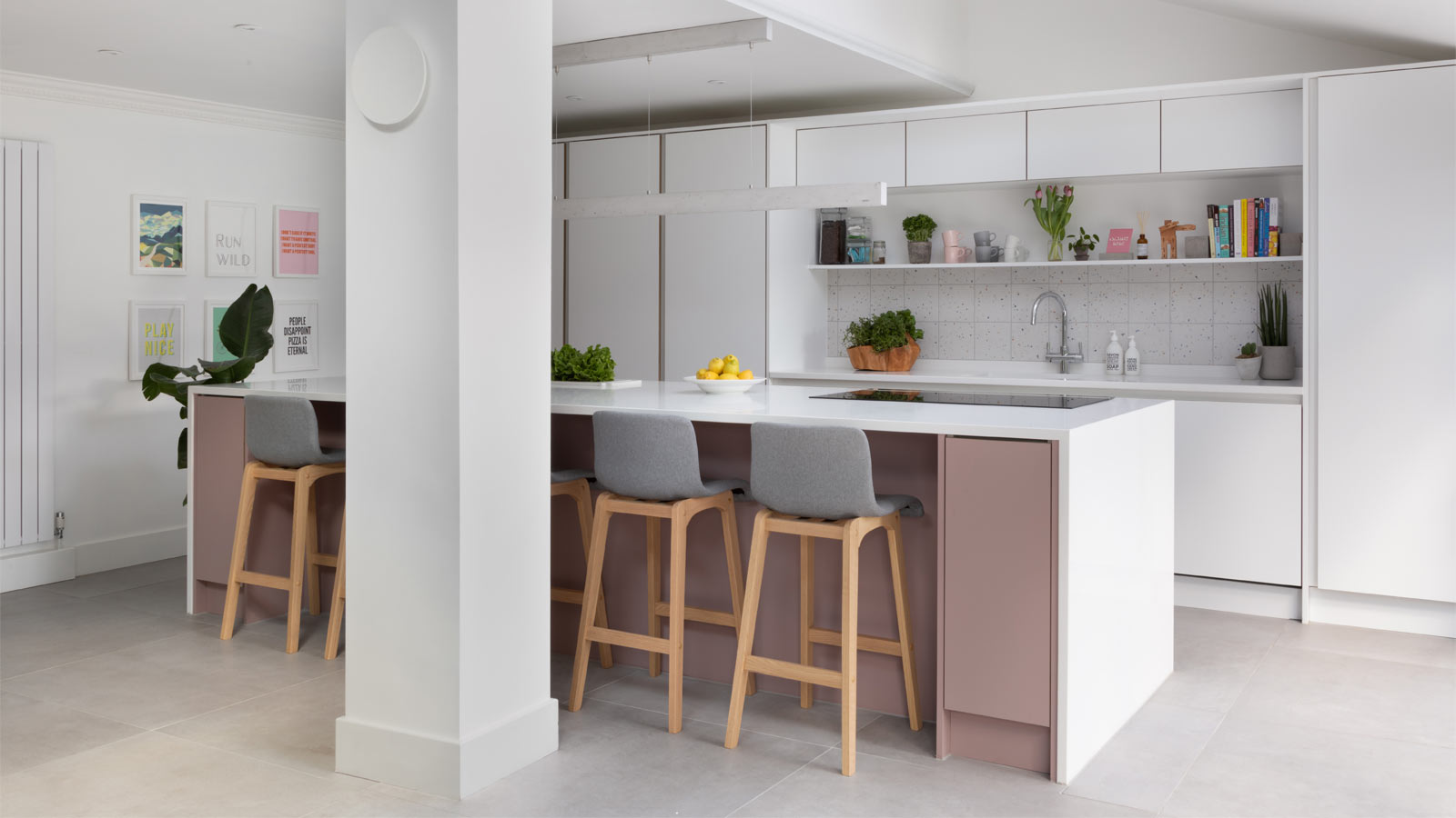 Open plan kitchen living room with pink kitchen island