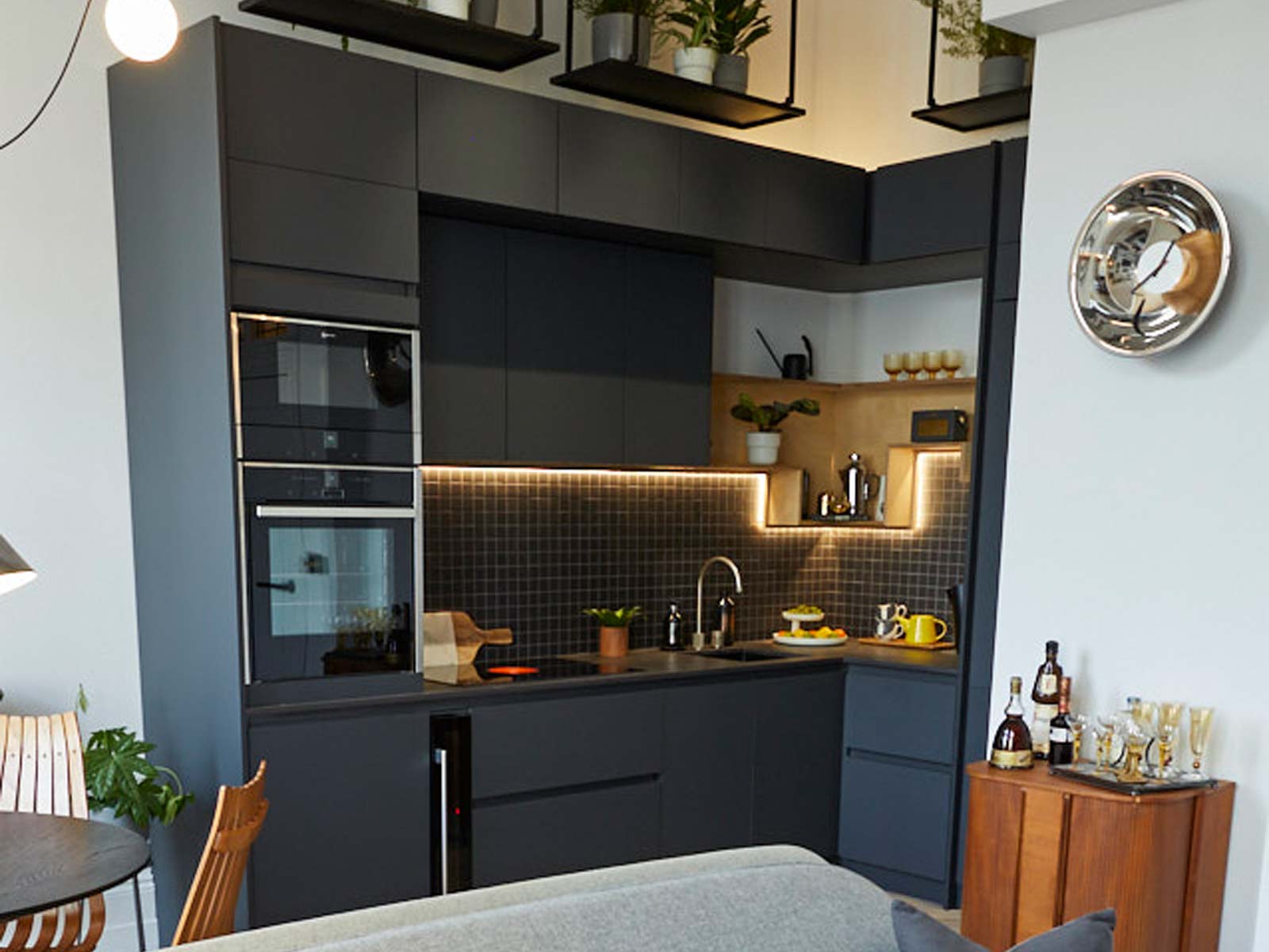 A galley-style open plan kitchen living room idea with a black handleless style