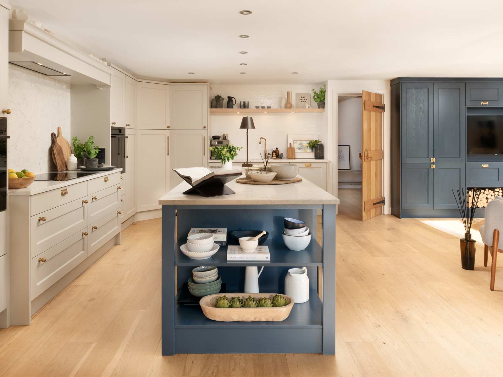 An open plan kitchen and lounge design with a kitchen island