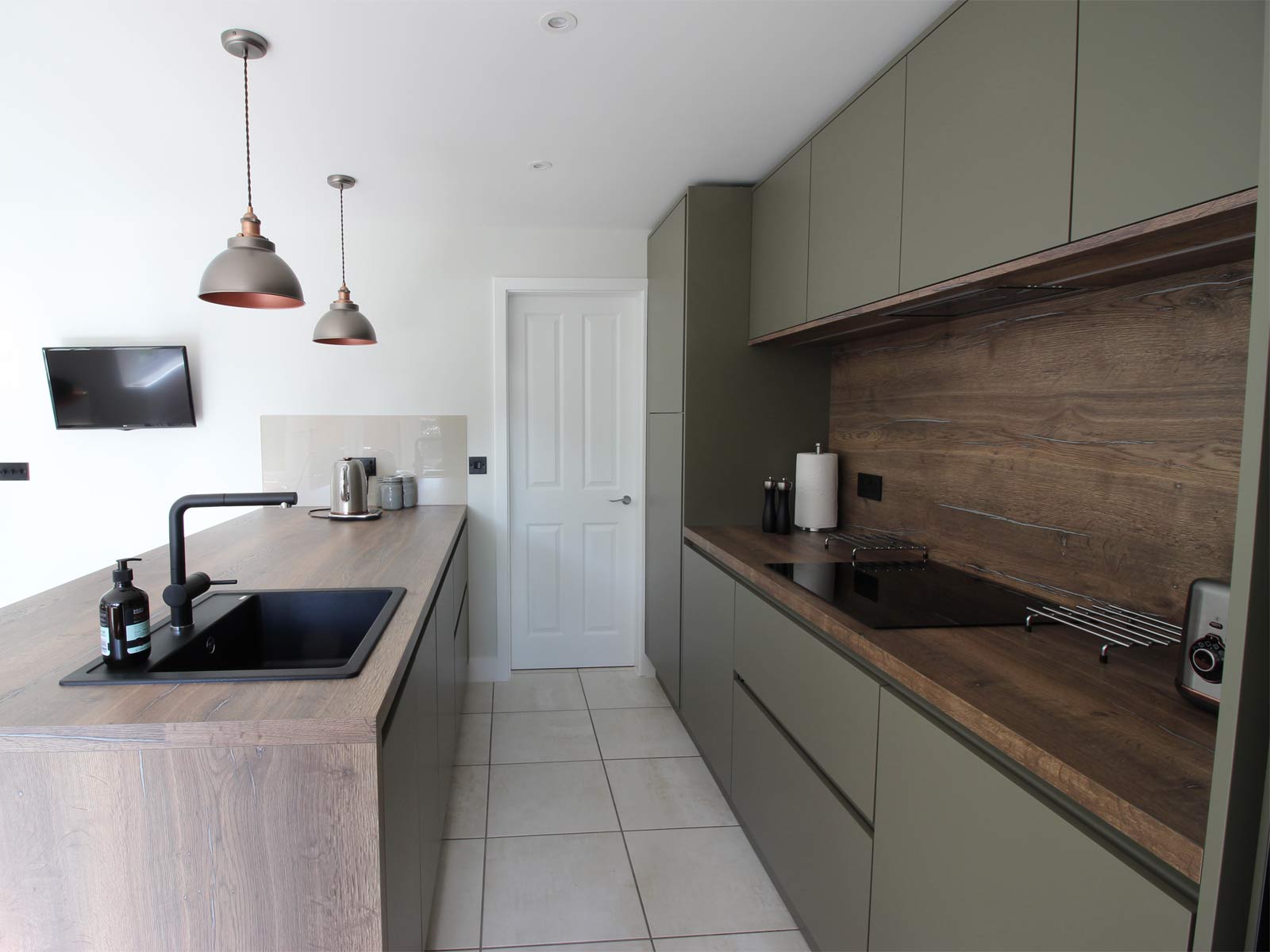 A galley open plan kitchen idea with a modern kitchen style