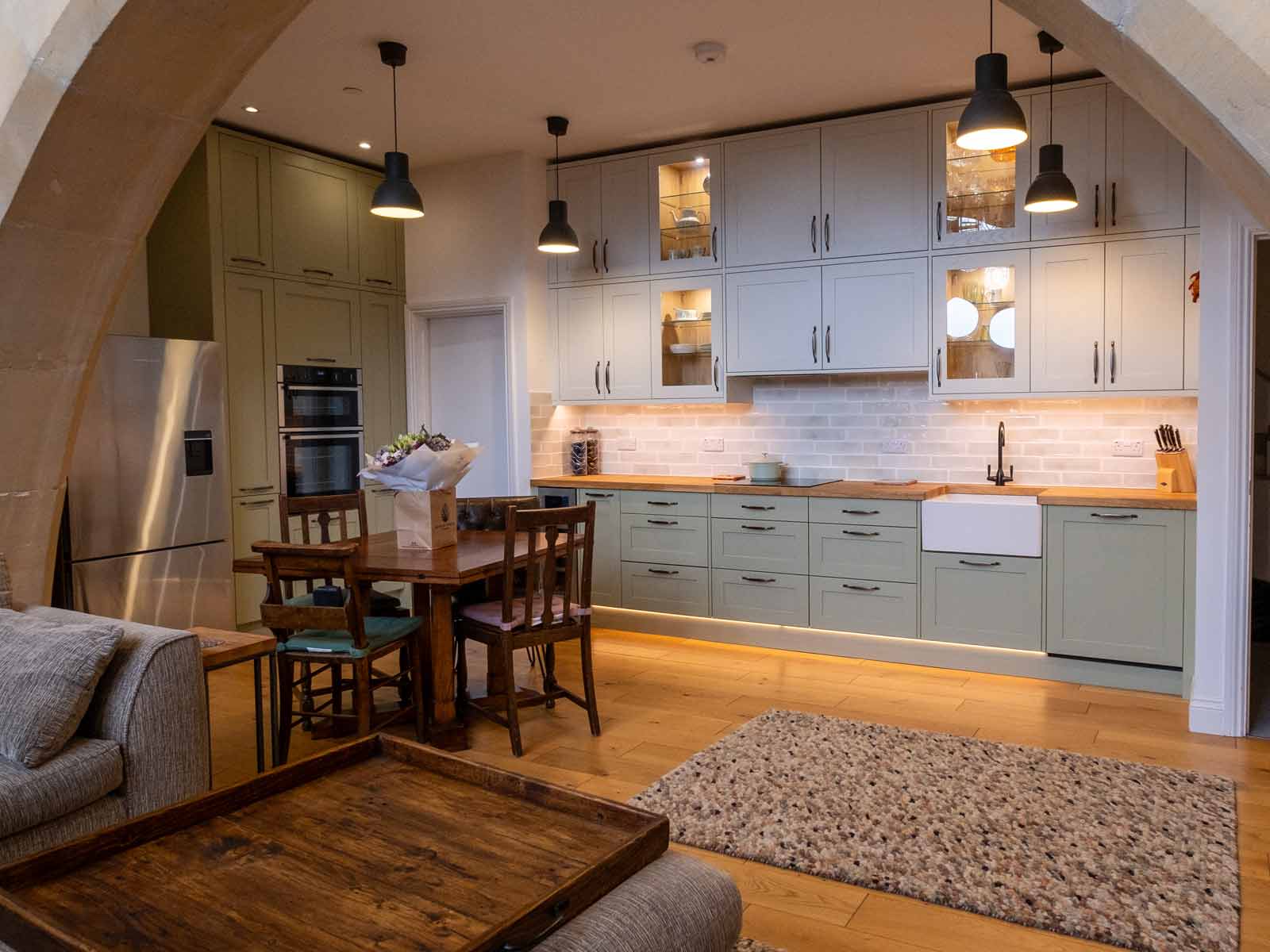 An L-shaped open space kitchen living room with a sustainable kitchen design