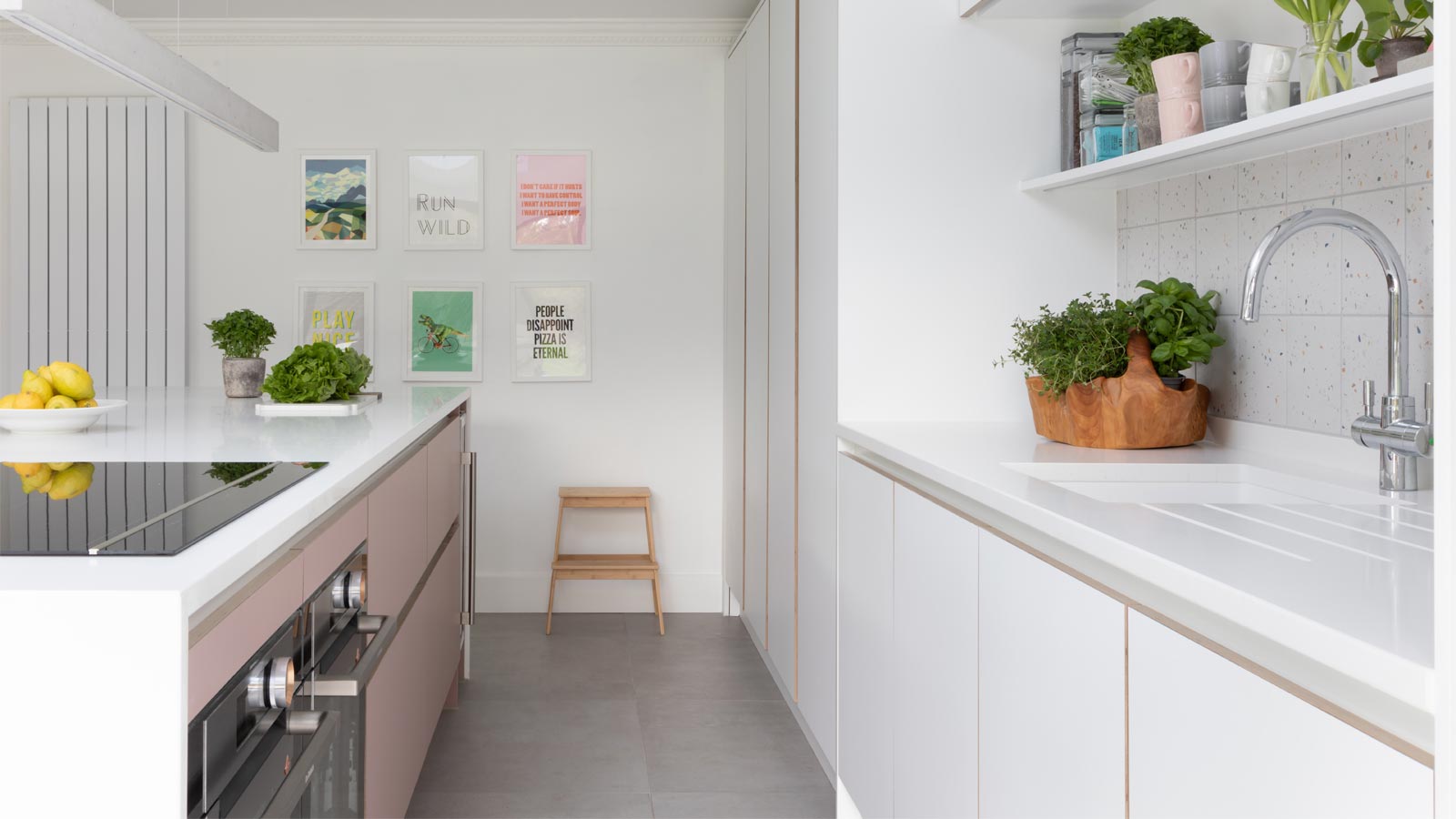 Pink and grey kitchen cabinets in an open plan kitchen