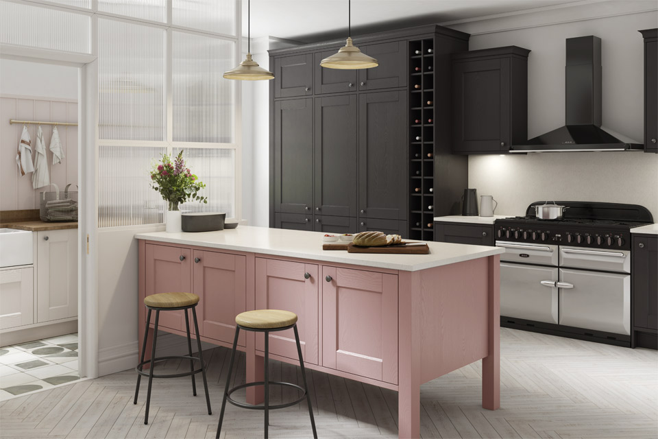 A pink and grey kitchen with white marble kitchen worktops