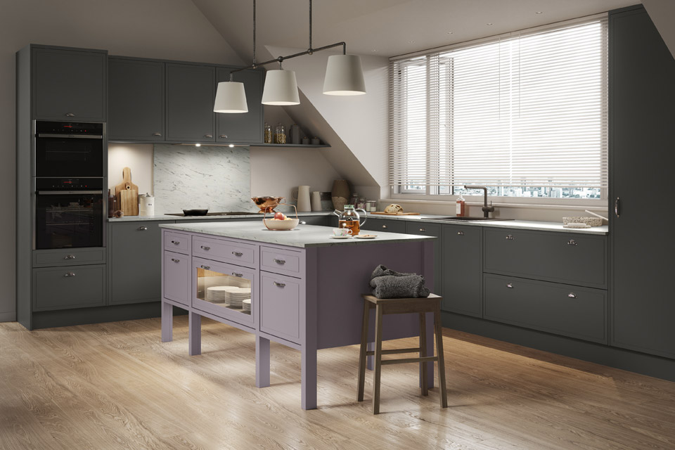 A grey and purple kitchen with white marble worktops