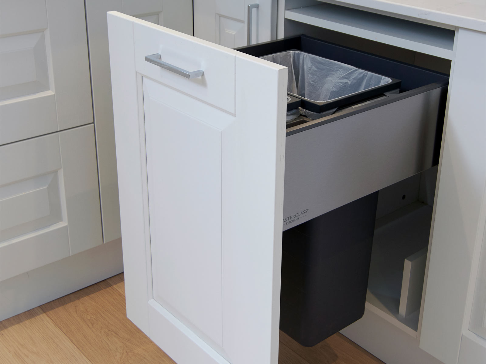 A Swedish-style kitchen bin, hidden in a white cupboard